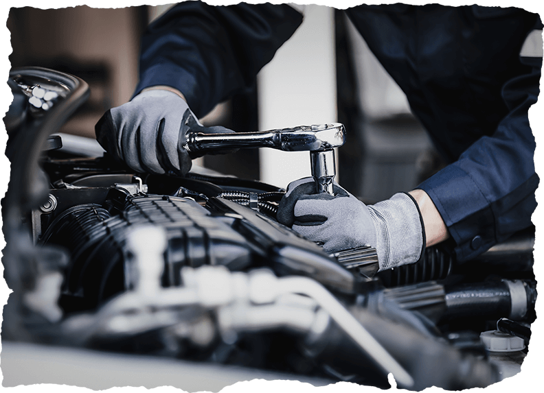 Professional mechanic working on the engine of the car in the garage